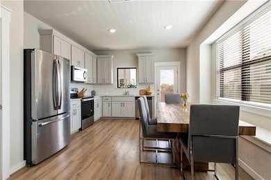 Kitchen with light wood-style floors, a sink, app