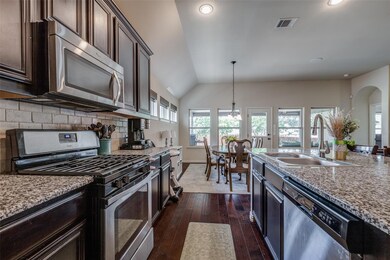 Kitchen featuring dark brown cabinets, decorative 