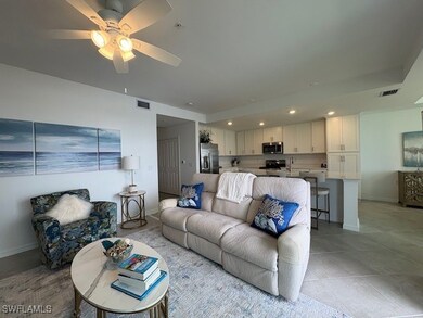 Living room featuring ceiling fan, light tile patterned floors