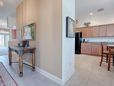 AN ARCHWAY (TO THE RIGHT OF THE FOYER) OPENS INTO 