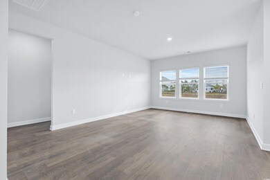 Empty room featuring dark wood finished floors, recessed lighting, and a smoke detector