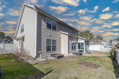 Rear view of property featuring a lawn