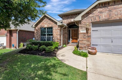 View of front of home with a garage and a front ya