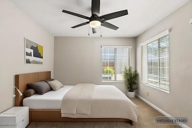 Carpeted bedroom with baseboards and ceiling fan