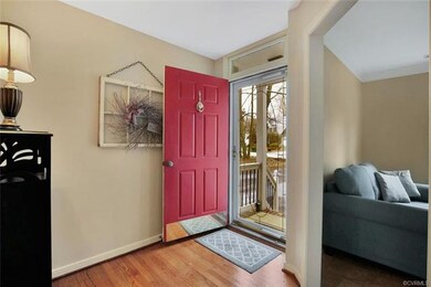 Foyer with wood floor and coat closet.
