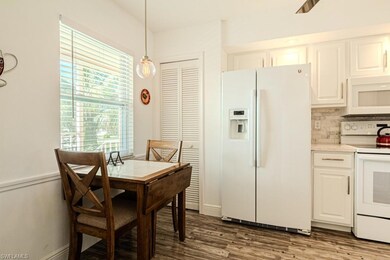 Dining space with dark hardwood / wood-style floor