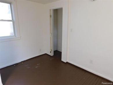 Unfurnished room with baseboards