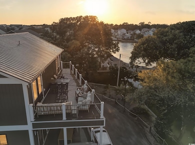 Aerial perspective of suburban area featuring a nearby body of water