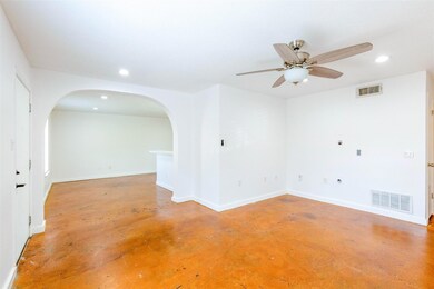 Empty room with arched walkways, concrete floors,