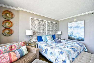 Bedroom with a textured ceiling and crown molding