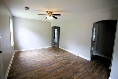 Empty room with ceiling fan and dark hardwood / wo