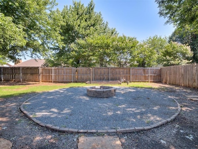 Fenced backyard featuring an outdoor fire pit
