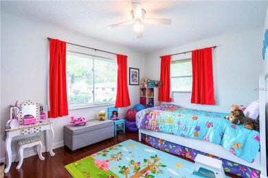 Large Secondary Bedroom with Wood Floor and Ceiling Fan