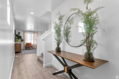 Corridor featuring light wood-style flooring and stairway