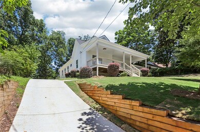Farmhouse-style home featuring a porch, a front lawn, and stairway