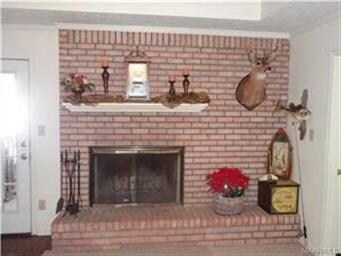 Attractive fireplace/hearth graces the great room.