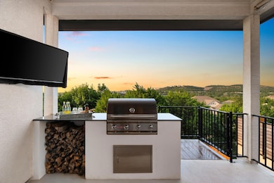 Patio terrace at dusk featuring area for grilling