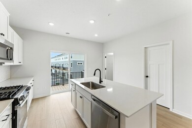 The perfect sized island offers additional prep space, storage, and seating. Similar home shown. Color and finish can vary.