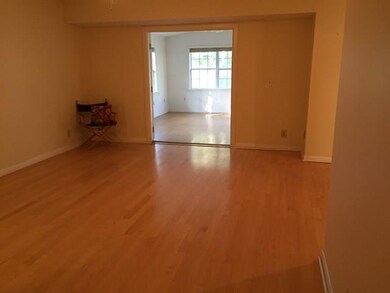 View from the foyer into the living room & sunroom