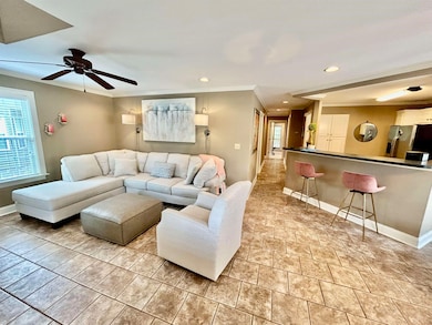 Living room with ornamental molding, baseboards, a ceiling fan, and recessed lighting
