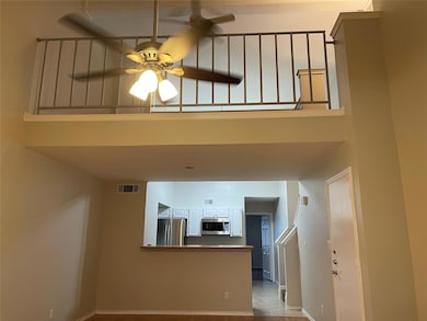 Kitchen featuring white cabinets, sink, ceiling fa