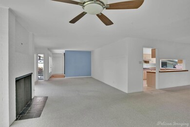 Living area with fireplace and picture windows