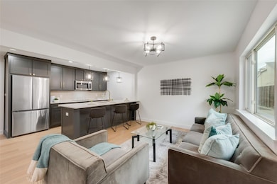 Living room with a chandelier, sink, and light har