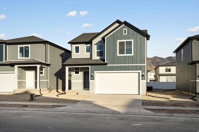 View of front of house featuring board and batten siding, an attached garage, driveway, a porch, and a mountain view