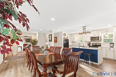 Dining area featuring light wood-style flooring and recessed lighting