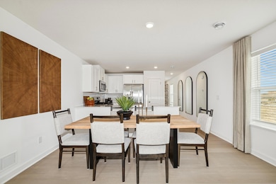 (*Photo of actual model home) This home offers a great eat-in dining space