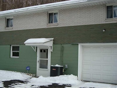 Exterior Back. Additional parking/storage in the 1
