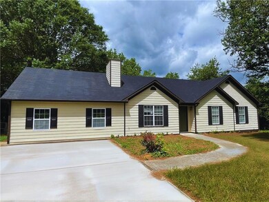 View of front of house featuring concrete driveway