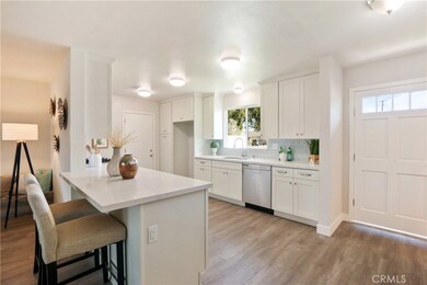 Remodeled kitchen with brand new shaker style cabinets, quartz counters, subway tile backsplash, waterproof vinyl plank flooring and stainless steel appliances.