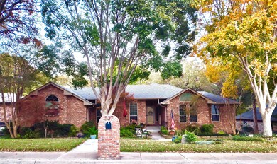 Ranch-style house with brick siding, a front lawn, and roof with shingles