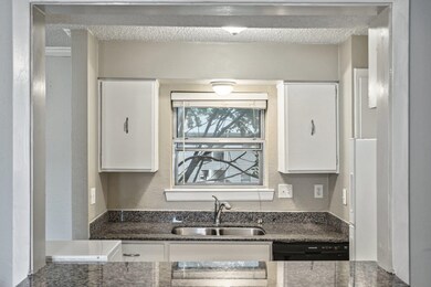 Kitchen featuring a textured ceiling, dishwasher, 