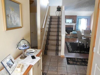 Foyer Entry with ceramic tile floor staircase to L