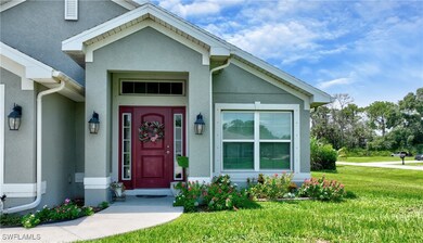 Doorway to property featuring a lawn