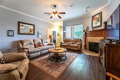 Living room featuring ceiling fan, dark wood-style