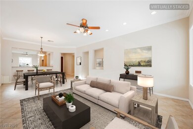 Living area with ceiling fan, ornamental molding,
