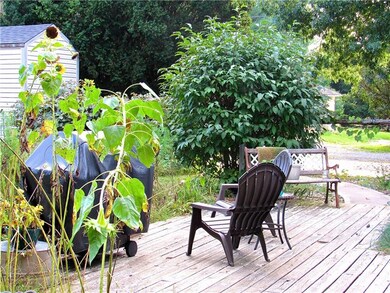Back deck leads to a grapevine arbor walkway to th