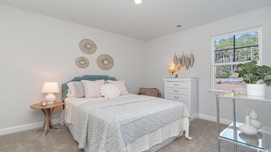 Bedroom with multiple windows and light colored ca