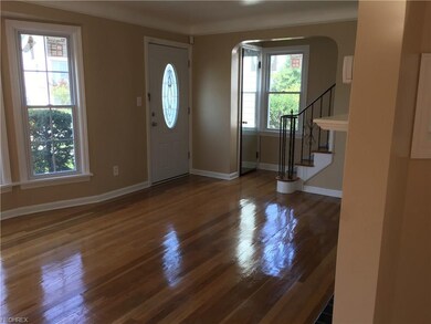 Large living room with gleaming hardwood floors, n
