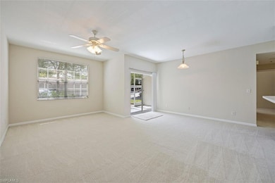 Unfurnished room featuring a ceiling fan and light carpet