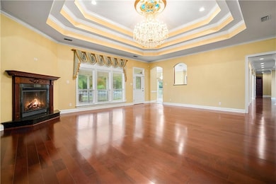 Unfurnished living room with ornamental molding, w