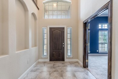 Bright entryway with separate office off entry.