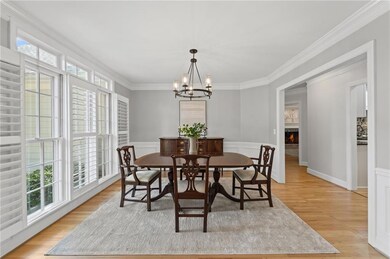 The bright formal dining room features classic tri