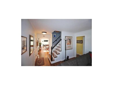 Central stairway divides the living room from dini