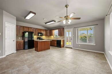 Kitchen with black appliances, tasteful backsplas