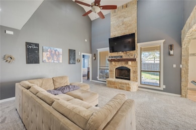 Living room featuring ceiling fan, high vaulted ce