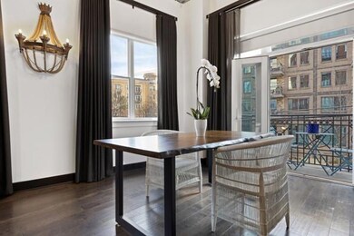 Dining area with wood finished floors, plenty of natural light, and baseboards